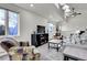 Spacious living area featuring plush seating, a modern entertainment center, and large windows for natural light at 6360 S Gibraltar Cir, Centennial, CO 80016