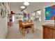 Open-concept living room and dining area with vaulted ceilings and a stone fireplace at 6360 S Gibraltar Cir, Centennial, CO 80016
