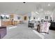 Bright and airy living room with vaulted ceilings, neutral carpet, and open layout to the kitchen at 6360 S Gibraltar Cir, Centennial, CO 80016