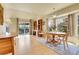 Open living area featuring a dining table, built-in bookcases, and sliding doors to an outdoor deck at 6360 S Gibraltar Cir, Centennial, CO 80016
