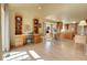 Bright, open-concept living space with dining area and kitchen featuring wood floors at 6360 S Gibraltar Cir, Centennial, CO 80016