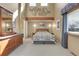 Spacious main bedroom featuring a decorative headboard, large dresser, and natural light at 6360 S Gibraltar Cir, Centennial, CO 80016
