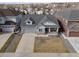 Aerial view of a two-story home with gray siding, stone accents, attached garage, and covered front porch at 20795 Scenic Park Dr, Parker, CO 80138