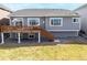 Well-maintained backyard with a raised wooden deck, and gray siding house at 20795 Scenic Park Dr, Parker, CO 80138