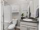 Well-lit bathroom featuring a clean shower, a vanity with sink, and a modern mirror with white cabinets at 20795 Scenic Park Dr, Parker, CO 80138