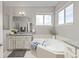 Bright bathroom featuring a soaking tub, granite countertop, and soft-close cabinets at 20795 Scenic Park Dr, Parker, CO 80138