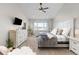 Cozy bedroom with a ceiling fan, large window, and plush bedding, showcasing neutral tones and modern design at 20795 Scenic Park Dr, Parker, CO 80138