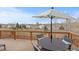 Outdoor deck featuring a table, chairs, and an umbrella, with a scenic view of the neighborhood at 20795 Scenic Park Dr, Parker, CO 80138
