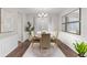 Well-lit dining room featuring decorative mirrors, hardwood floor, chandelier, and elegant wainscoting at 20795 Scenic Park Dr, Parker, CO 80138