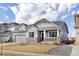 Beautiful two-story home with gray siding, stone accents, attached garage, and a cozy covered front porch at 20795 Scenic Park Dr, Parker, CO 80138