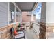 Inviting covered front porch with comfortable seating and stone accents, perfect for relaxing outdoors at 20795 Scenic Park Dr, Parker, CO 80138