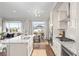 Open-concept kitchen and dining area filled with natural light and modern appliances on hardwood flooring at 20795 Scenic Park Dr, Parker, CO 80138