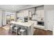 Bright kitchen boasting a marble island with bar stool seating, stainless steel appliances, and hardwood floors at 20795 Scenic Park Dr, Parker, CO 80138