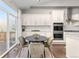 Open kitchen and dining area with white cabinets, stainless appliances, and access to the patio at 20795 Scenic Park Dr, Parker, CO 80138