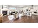 Open-concept living room with fireplace flowing into the dining area and kitchen, perfect for entertaining at 20795 Scenic Park Dr, Parker, CO 80138