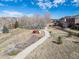 Community playground nestled in a neighborhood park with walking paths and trees at 20795 Scenic Park Dr, Parker, CO 80138
