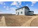 Backyard view showing the back of the house and newly landscaped, undeveloped yard at 14366 Heritage Dr, Mead, CO 80504