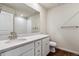 Bathroom features dual-sink vanity, white cabinetry, a large mirror, and a shower with white tile at 14366 Heritage Dr, Mead, CO 80504
