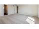 Bright bedroom features carpeted flooring, neutral walls, and an open doorway to the staircase at 14366 Heritage Dr, Mead, CO 80504