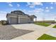 Stylish home with a two-car garage, a long driveway, and well-maintained landscaping on a sunny day at 14366 Heritage Dr, Mead, CO 80504