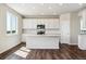 Beautiful kitchen featuring white cabinetry, stainless appliances, island, and hardwood floors at 14366 Heritage Dr, Mead, CO 80504