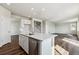 Island kitchen with stainless dishwasher, and open floor plan at 14366 Heritage Dr, Mead, CO 80504