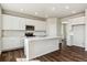 Beautiful kitchen featuring white cabinetry, stainless appliances, island, and hardwood floors at 14366 Heritage Dr, Mead, CO 80504