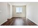 Open living space featuring hardwood floors, white walls, and a window to let in natural light at 14366 Heritage Dr, Mead, CO 80504