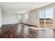 Spacious living room featuring wood floors, white walls, and large sliding doors leading to the outside at 14366 Heritage Dr, Mead, CO 80504