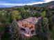 Breathtaking aerial view of the beautiful home nestled among mature trees, showcasing the serene and private setting at 5904 Meadowbrook Dr, Morrison, CO 80465
