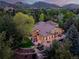 Stunning aerial view of the property with a large yard and mountain views at 5904 Meadowbrook Dr, Morrison, CO 80465
