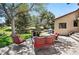 Inviting brick back patio with outdoor seating and a beautiful landscaped backyard at 5904 Meadowbrook Dr, Morrison, CO 80465