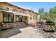 Spacious back patio with stone fireplace, awning, and outdoor seating area at 5904 Meadowbrook Dr, Morrison, CO 80465