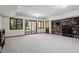 Basement area with carpet, built-in bookshelves, a sliding glass door to the outside, and windows at 5904 Meadowbrook Dr, Morrison, CO 80465