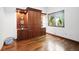 Neat bedroom features hardwood floors, a custom wooden cabinet, and a window at 5904 Meadowbrook Dr, Morrison, CO 80465