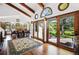 Open-concept dining area with access to the patio, highlighted by hardwood floors, elegant lighting and natural light at 5904 Meadowbrook Dr, Morrison, CO 80465