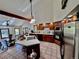 Spacious kitchen with stainless steel appliances, a tile island, and a vaulted ceiling at 5904 Meadowbrook Dr, Morrison, CO 80465