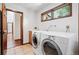 Bright laundry room features modern washer and dryer, a sink, and a window for natural light at 5904 Meadowbrook Dr, Morrison, CO 80465
