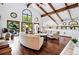 Comfortable living room with large windows, hardwood floors, and stylish sofas, perfect for relaxation and entertaining at 5904 Meadowbrook Dr, Morrison, CO 80465
