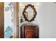 Powder room with a wood vanity, decorative mirror, and sconce lighting at 5904 Meadowbrook Dr, Morrison, CO 80465