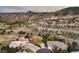 Expansive aerial view of a neighborhood nestled among picturesque mountains and featuring beautiful homes at 6321 Spotted Fawn Run, Littleton, CO 80125