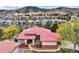 Panoramic aerial view showcasing a beautiful home with a red tile roof surrounded by lush greenery at 6321 Spotted Fawn Run, Littleton, CO 80125