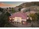 A captivating aerial view showing a well-maintained home with a tile roof and a covered patio against a hillside backdrop at 6321 Spotted Fawn Run, Littleton, CO 80125