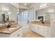 Elegant bathroom with a soaking tub, dual sinks, and stylish fixtures at 6321 Spotted Fawn Run, Littleton, CO 80125