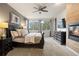 Spacious primary bedroom with a cozy fireplace and serene views at 6321 Spotted Fawn Run, Littleton, CO 80125