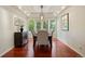 Bright dining room with hardwood floors, decorative ceiling, and large windows with backyard view at 6321 Spotted Fawn Run, Littleton, CO 80125