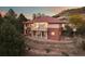 Exterior of home with a red tiled roof and a stone retaining wall at 6321 Spotted Fawn Run, Littleton, CO 80125