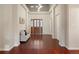 Elegant foyer with hardwood floors, a seating area, and a striking front door at 6321 Spotted Fawn Run, Littleton, CO 80125