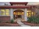 Inviting front entrance with a tiled porch, decorative door, and manicured landscaping offering a warm welcome at 6321 Spotted Fawn Run, Littleton, CO 80125