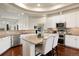 Modern kitchen featuring a large island, stainless steel appliances, and sleek countertops at 6321 Spotted Fawn Run, Littleton, CO 80125